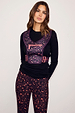 Leopard Running Bag in a dark plum animal print with a coral front zip, worn over a black top and matching leggings.