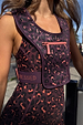 Dark leopard print running bag with a pink front zip and branded strap, worn over matching animal print activewear.