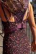 Leopard Running Bag in dark plum leopard print with branded straps, worn over a matching leopard print outfit.