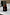 Thumbnail for NFD Eau De Parfum 001 in a dark amber glass bottle with a tortoiseshell cap on a white marble surface.