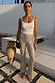 Silver Sequin Diva Trouser with a flared leg, styled with a white camisole, gold necklace and silver bangles.