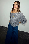 Gunmetal Sequin Tilly Top with an off-the-shoulder neckline, styled with dark blue wide-leg denim jeans.