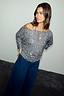 Gunmetal Sequin Tilly Top with an asymmetric off-the-shoulder neckline, paired with dark wide-leg denim.