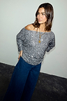 Gunmetal Sequin Tilly Top with an asymmetric off-the-shoulder neckline, paired with dark wide-leg denim.