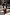 Thumbnail for Iconic Silver Sequin Mini Maeva Skirt with green lace trim, styled with a black blazer and maroon boots on a city street.