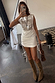 White Sequin Ruched Dress with a sequin chest panel and adjustable side ruching, styled with tall boots.