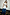 Thumbnail for White Sequin Ruched Dress with silver sequin embroidery and side ties, styled over wide-leg blue jeans.