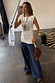 White Sequin Ruched Dress featuring a silver sequin panel and adjustable side ruching, styled over wide-leg denim.