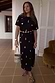 Black Shell Midi Leia Dress with gold shell prints, featuring a casual t-shirt bodice and wrap-tie skirt.
