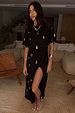 Black Shell Midi Leia Dress with a gold shell print, t-shirt bodice and wrap skirt with a high slit.
