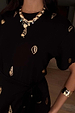 Black Shell Midi Leia Dress featuring gold shell prints and chunky gold jewellery.