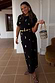 Black Shell Midi Leia Dress featuring a gold shell print and wrap detail, styled with a woven bag.