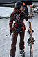 Night Garden Ski Jacket featuring iconic leopard and poppy motifs, belted and worn on a snowy mountain slope.