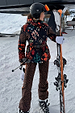 Night Garden Ski Jacket featuring iconic leopard and poppy motifs, belted and worn on a snowy mountain slope.