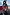 Thumbnail for Night Garden Ski Jacket featuring leopard and poppy motifs, styled with a belt inside a mountain gondola.
