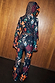 Night Garden Ski Suit featuring a hooded back view with leopard and mystical motifs in a patchwork print.