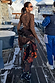 Night Garden Ski Suit with leopard and poppy motifs, worn by a model on a snowy mountain terrace.