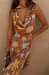 Star Fawn Sophie Dress in brown with star and sun motifs, featuring a draped neck and matching neck scarf.