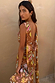 Star Fawn Sophie Dress in brown with a low back and detachable scarf detail, held with a matching clutch.