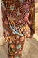 Multi-wear Star Fawn Bandana with sun and palm motifs, tied around the waist over a matching fawn spot print dress.