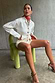 Thumbnail for Ecru Studded Cardigan with silver studs on the sleeves, styled with matching shorts for a structured look.