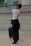 Thumbnail for Black Vegan Leather Studded Leg Trousers with silver side studs, styled with a white tee and heels for a street style look.