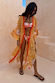 Yellow Sun Kimono with a Soleil sun print and contrast trim, styled over a bikini for a vacation-ready look.
