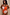 Thumbnail for Orange Sun Bandeau Swimsuit with white sun motifs and gold bead embroidery, worn by a model in sunglasses.