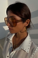 70s-inspired Orange Acetate Visor Sunglasses with warm brown tinted lenses, worn by a model.