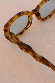 Yellow Tort Wiggle Arm Sunglasses with light blue lenses and a gold NFD logo on the signature wavy arm.