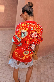 Tomato Tapestry Martha Cardigan in red with celestial sun motifs, shown from the back in a relaxed fit.