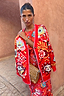 Thumbnail for Red Tomato Tapestry Martha Cardigan with celestial sun motifs and pink blanket stitch edging on a model.
