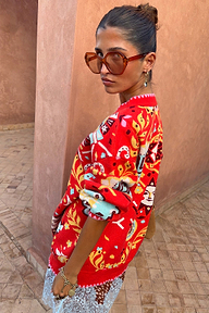 Tomato Tapestry Martha Cardigan with celestial motifs and pink blanket stitch, styled with oversized sunglasses.