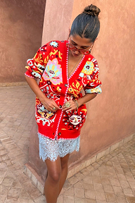 Tomato Tapestry Martha Cardigan with celestial motifs and pink blanket stitch over a blue lace slip skirt.