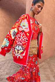 Tomato Tapestry Martha Cardigan with pink blanket stitch detailing layered over a matching red print dress.