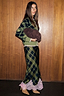 Green and black Olive Tartan Maeva Skirt featuring a pink lace hem, styled with a matching tartan cardigan.