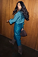 Teal Vegan Leather Jaspre Skirt worn with a matching teal blouse and tall brown suede boots.
