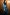 Thumbnail for Teal Vegan Leather Jaspre Skirt styled with a matching teal shirt and a brown studded clutch.