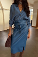 Teal Vegan Leather Jaspre wrap skirt styled with a blue button-up shirt and brown suede bag.