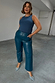 Teal Vegan Leather Trousers in a straight leg fit, paired with a blue tank top and embellished heels.