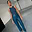 Model wearing Teal Vegan Leather Trousers in a straight leg fit, paired with a blue ribbed tank top.