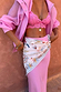 Cream Bandana in Tigress Print featuring pastel paisley motifs, multi-wear styled as a waist wrap over a pink skirt.