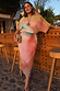 Abstract Tilly midaxi dress featuring a multicoloured pleated print with metallic gold flecks on a model.