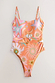 Orange Dreamer Scoop Swimsuit with celestial palm and sun prints, featuring a statement buckle and adjustable straps.