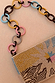 Soleil Bag featuring hand-embellished beadwork in a sun print and a colourful chunky chain link strap.