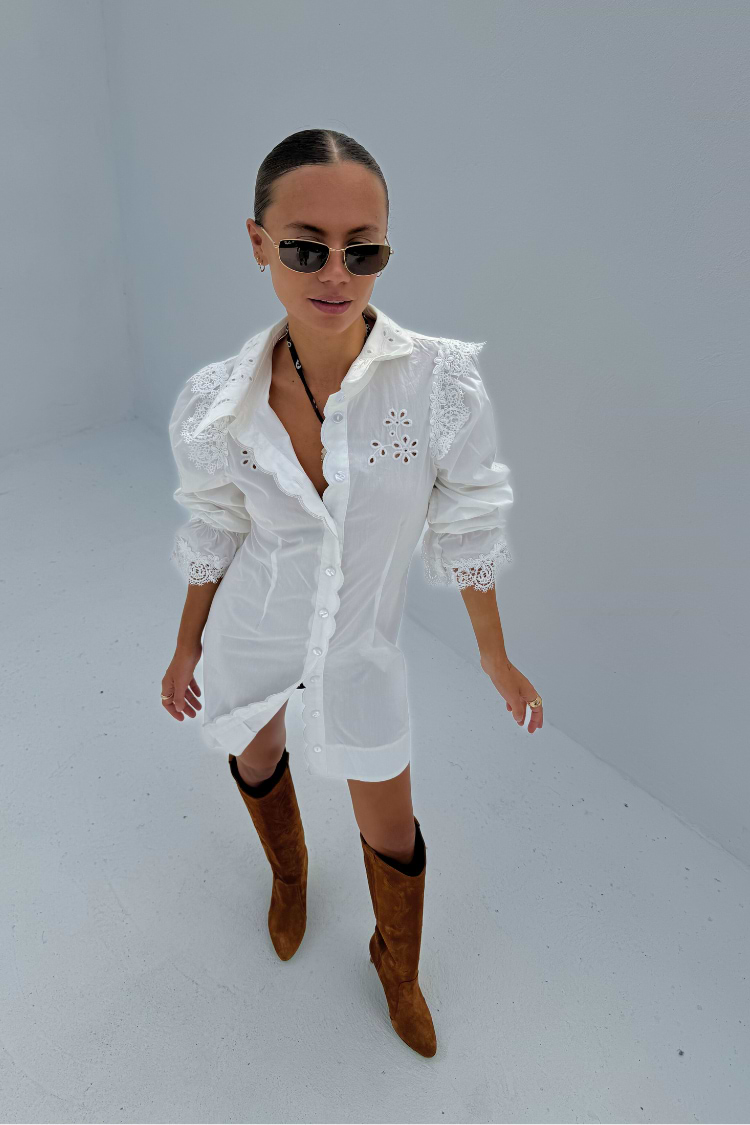 model is wearing our white sicily shirt dress with knee high suede brown boots