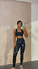 Peace Athleisure Crop Top and leggings set with a colourful peace sign and star print in a mirror selfie.
