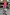 Thumbnail for Gingham Macy Midi Dress with pink rickrack trim, layered with a pink cardigan and leopard print sandals.