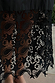 Detail of the star lace pattern and sheer hemline on the Black Star Sasha Dress.