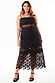 Black cotton Sasha Dress featuring star lace patterns and a sheer hemline on a model facing the camera.